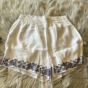 Bebe Embroidered ruffle waist short